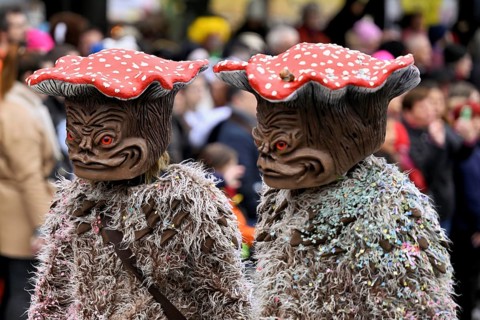 Two people masked as toadstools at the carnival parade of the Wey guild on Rose Monday,