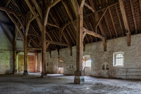 Interior showing wooden truss of 13th century Gothic monastic tithe barn of the Ter Doest Abbey at