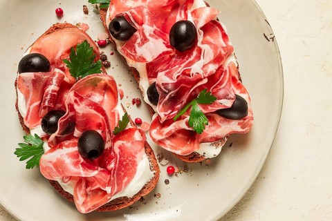 Sandwich with cream cheese, prosciutto with olives, breakfast