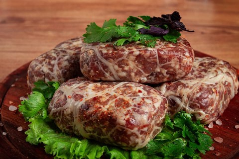 Raw apkhazura, a dish of Georgian cuisine, meat balls, minced meat wrapped in a fat net, seftalia,