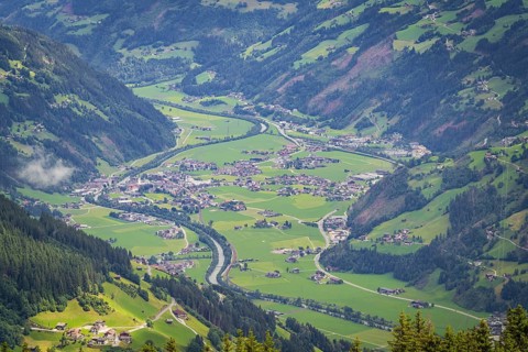 Green valley with village and river in the Alps, surrounded by mountains, Mayrhofen, Zillertal.