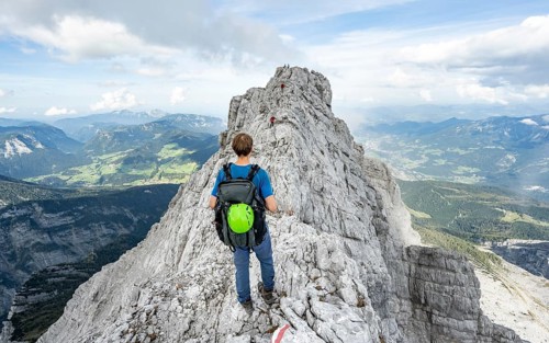 Mountaineer on a narrow rocky ridge, Watzmann crossing to Watzmann Mittelspitze, view of mountain