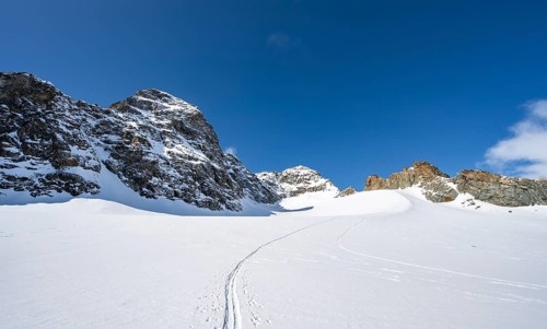 Rocky mountain peak of Piz Kesch and glacier Vadret da Porchabella in winter, mountain landscape,