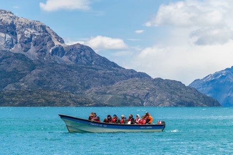Excursion boat with tourists in front of the marble caves Capillas de Marmol, Lago General Carrera,