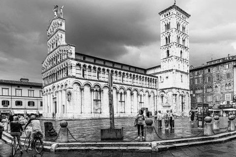 Dark rain clouds over the bell tower of the church of San Michele in Foro, and Piazza San Michele,