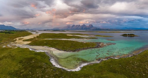 View of mountain range Seven Sisters from Herøy island, light mood with rainbow, Helgeland coast,