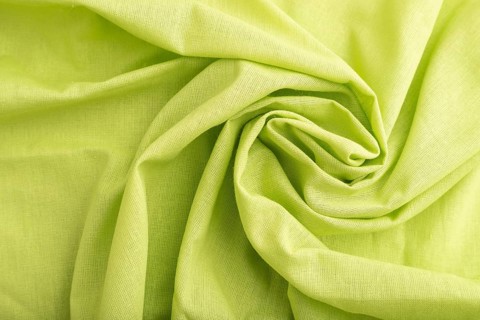Fragment of green linen tissue. Top view, flat lay, natural textile background and texture. wave