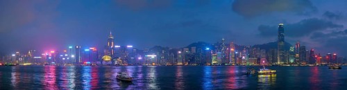 Panorama of Hong Kong skyline cityscape downtown skyscrapers over Victoria Harbour in the evening