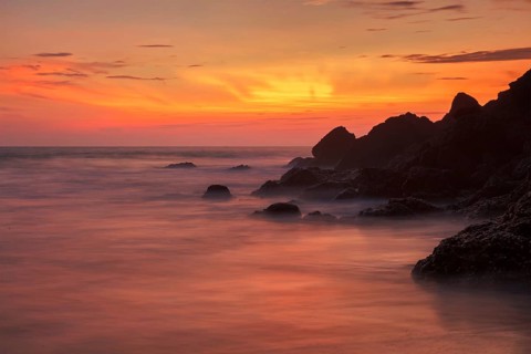 Sunset on Varkala beach popular tourist destination in Kerala state, South India. Long exposure