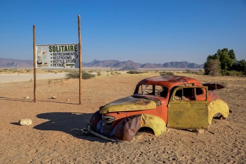 Rusty car wreck in sand, Solitaire, Hardap Region, Namibia, Africa