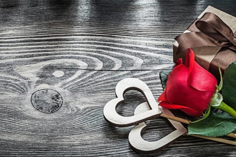 Wooden hearts red rose present box on wood board celebrations concept
