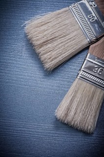 Paintbrushes on wooden board vertical version construction concept