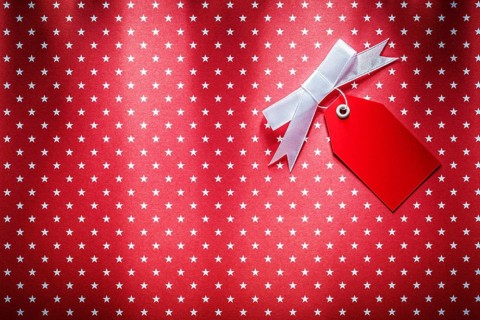 Sale tag on red fabric shopping concept