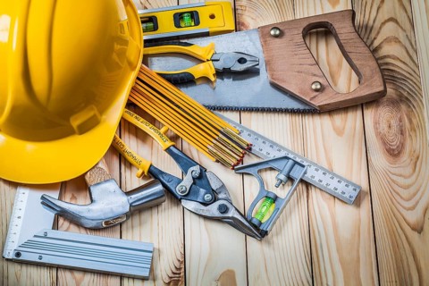 Tools and helmet on wooden boards