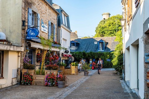 Pont-Aven, France, August 5, 2018: Picturesque street in the walled medieval town. Sunny day
