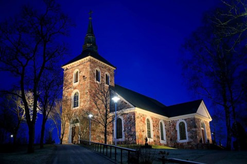 Illuminated Uskela Church, designed by Finnish architect C. L. Engel and built 1832, in winter