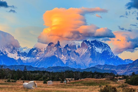 Incredible clouds illuminated by the sunset. The granite towers of Cuernos del Paine. White