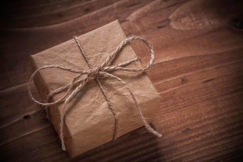 Classical vintage gift box with string bow on wooden board
