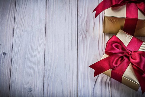 Gift boxes with ribbon on wooden board copy space holidays concept