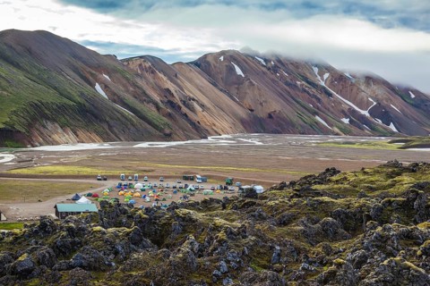 The valley is large tourist camp. Pink and green rhyolite mountains surround the flat valley of the