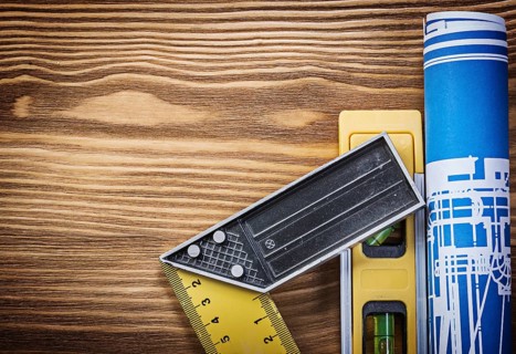 Blue construction drawing level try square on wooden board