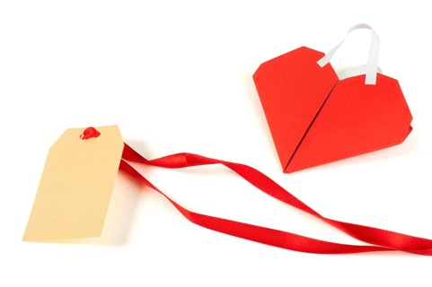 Heart made ??of curled red paper and label. White isolated