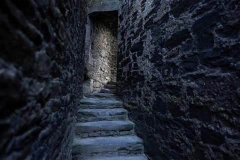 Conwy Castle, medieval stone staircase of the castle winds through narrow, dark and historic