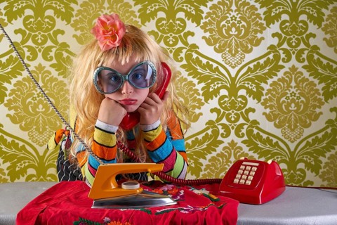 Sad housewife kid girl iron chores talking at red retro phone vintage humor