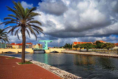A view of a bridge in willemstad on curacao with blue sky and beautiful clouds
