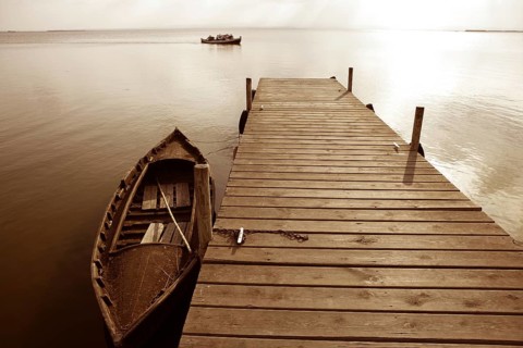 Albufera lake wetlands pier with boat in Valencia Spain