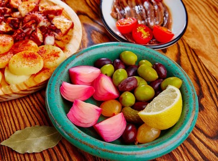 Olives and onion pickles tapas with anchovies and octopus gallega