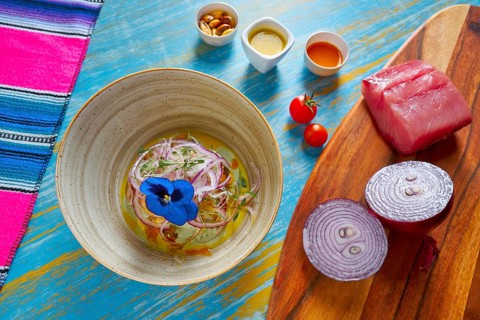 Fish ceviche latin preuvian recipe on bowl with pansy flower