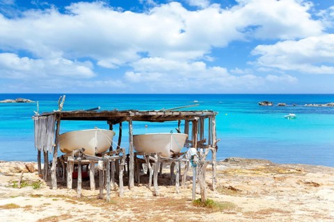 Beached boats in Formentera Els Pujols beach with turquoise water