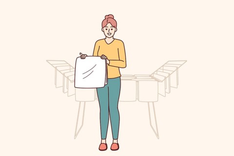 Woman housewife stands near dryer with clean towels doing household chores to create comfort in