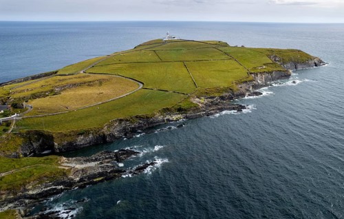 Drone aerial seascape of galley head lighthouse. Dundeady headland island cork county ireland