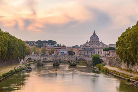 Sunset view of St. Peter's Basilica, Ponte Sant'Angelo, and Tiber River in Rome, Italy, Europe