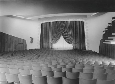 Cinema in the 1940s. An interior of a typical looking movie theatre with seats near the film screen