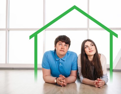 Happy young couple lying on the floor at home, dreaming