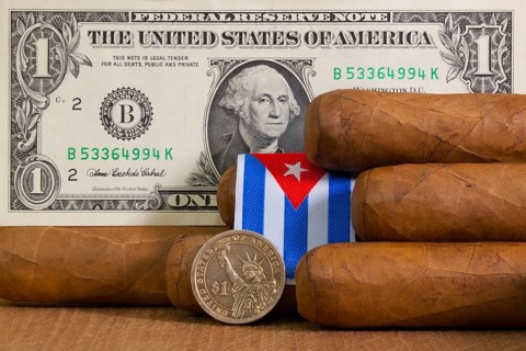 Luxury Cuban cigars with US dollar banknote and coin on the wooden table