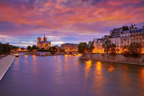 Notre Dame cathedral in Paris sunset from Seine river in France