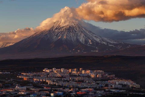 Evening colorful top view of townscape of Petropavlovsk-Kamchatsky City at sunset on background