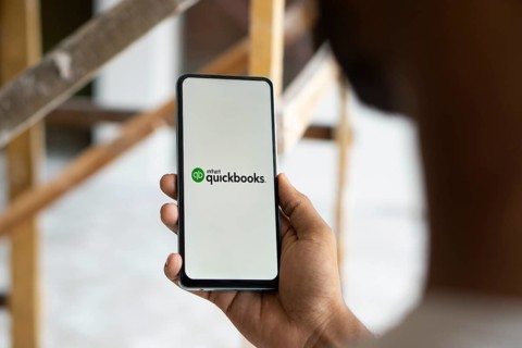 Intuit quickbooks logo is displayed on smartphone. QuickBooks is an accounting software.