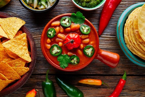 Frijoles charros mexican beans with chili pepper sides and tortillas