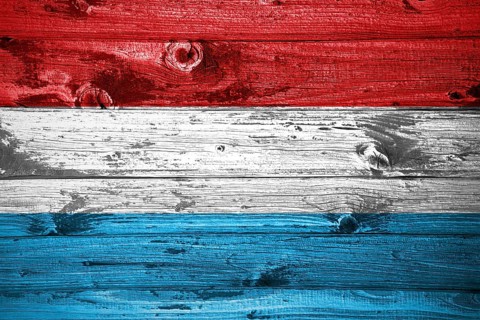 Luxembourg flag on wooden planks background wood flag
