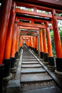 Red Tori Gate at Fushimi Inari Shrine in Kyoto, Japan. One of the largest tourist attractions in