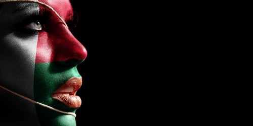 Madagascar flag painted on a face of a young woman, national flag on face