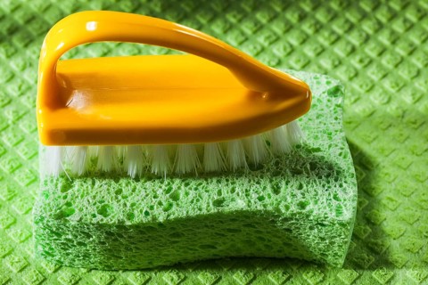 New plastic brush sponge on dishcloth