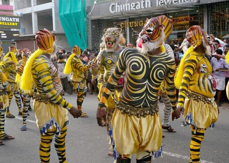Trained dancers with their carefully painted bodies guise of tigers perform the famous Pulikali the