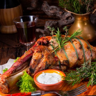 Grilled shoulder of lamb braised in the oven with rosemary