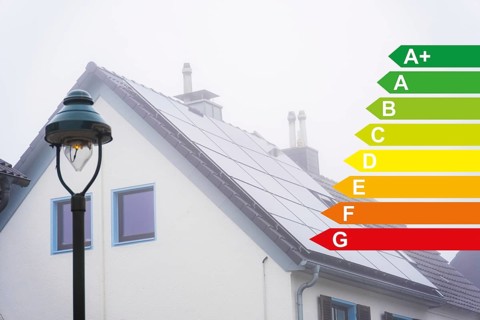 Solar panels on the roof of a detached house in the fog, energy efficiency classes according to the